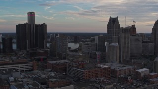 DX0002_192_036 - 5.7K aerial stock footage of flying by skyscrapers at sunset to reveal a hotel, Downtown Detroit, Michigan