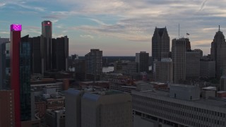 DX0002_192_037 - 5.7K aerial stock footage flyby a hotel at sunset and focus on the city's skyscrapers, Downtown Detroit, Michigan