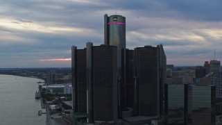 DX0002_192_039 - 5.7K aerial stock footage approach and orbit riverfront skyscraper at sunset, Downtown Detroit, Michigan