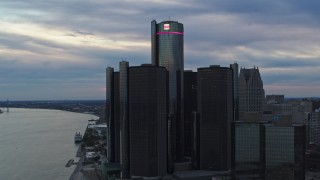 DX0002_192_041 - 5.7K aerial stock footage approach the GM Renaissance Center skyscraper at sunset, Downtown Detroit, Michigan