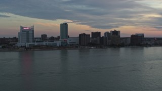 DX0002_192_048 - 5.7K aerial stock footage ascend from the river for view of skyline, Windsor, Ontario, Canada, sunset