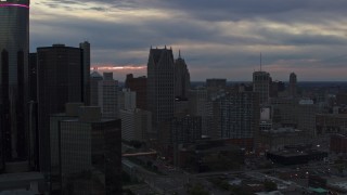DX0002_192_052 - 5.7K aerial stock footage of skyscrapers at sunset, reveal GM Renaissance Center, Downtown Detroit, Michigan