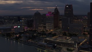 DX0002_193_003 - 5.7K aerial stock footage of tall downtown skyscrapers at twilight seen from the river, Downtown Detroit, Michigan