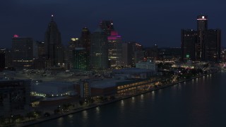 DX0002_193_006 - 5.7K aerial stock footage focus on skyscrapers while flying by convention center at twilight, Downtown Detroit, Michigan