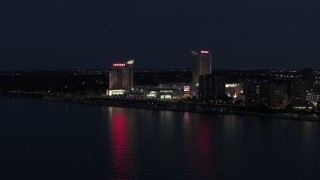 DX0002_193_012 - 5.7K aerial stock footage of Caesar Windsor hotel and casino at night, Windsor, Ontario, Canada