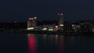DX0002_193_013 - 5.7K aerial stock footage of flying by Caesar Windsor hotel and casino at night, Windsor, Ontario, Canada