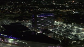 DX0002_193_020 - 5.7K aerial stock footage reverse view of lights on the MotorCity Casino Hotel building at night, Detroit, Michigan