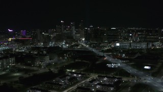 DX0002_193_024 - 5.7K aerial stock footage flying by Grand River Avenue with view of skyline at night, Downtown Detroit, Michigan