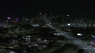 DX0002_193_025 - 5.7K aerial stock footage flying near Grand River Avenue while focused on skyline at nighttime, Downtown Detroit, Michigan