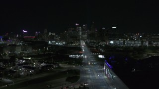 DX0002_193_026 - 5.7K aerial stock footage flying by Grand River Avenue, focus on skyline at night, Downtown Detroit, Michigan