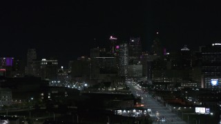 DX0002_193_033 - 5.7K aerial stock footage fly from Grand River Avenue, focus on skyline at night, Downtown Detroit, Michigan