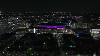 DX0002_193_037 - 5.7K aerial stock footage approach and fly away from Little Caesars Arena at night, Detroit, Michigan