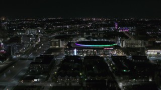 DX0002_193_038 - 5.7K aerial stock footage of approaching Little Caesars Arena at night, Detroit, Michigan
