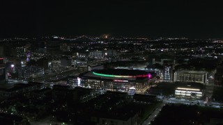 DX0002_193_040 - 5.7K aerial stock footage of circling Little Caesars Arena at night, Detroit, Michigan