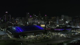 DX0002_193_042 - 5.7K aerial stock footage of the city's skyline and sports stadiums at night, Downtown Detroit, Michigan
