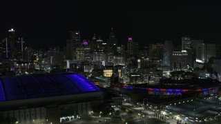 DX0002_193_044 - 5.7K aerial stock footage view of skyline from Comerica Park, reveal Ford Field at night, Downtown Detroit, Michigan