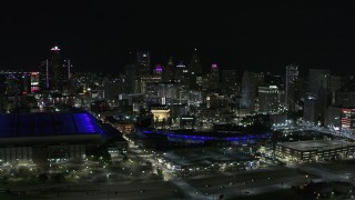 DX0002_193_046 - 5.7K aerial stock footage fly away from Comerica Park and skyline at night, reveal Ford Field, Downtown Detroit, Michigan