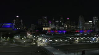 DX0002_193_050 - 5.7K aerial stock footage descend near Comerica Park at night with view of skyline, Downtown Detroit, Michigan