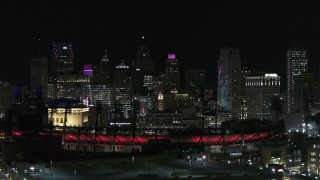 DX0002_193_058 - 5.7K aerial stock footage descending by Comerica Park and skyline at night, Downtown Detroit, Michigan