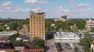 DX0002_194_016 - 5.7K aerial stock footage of slowly orbiting an apartment building in Detroit, Michigan