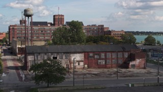 DX0002_194_020 - 5.7K aerial stock footage descend by an abandoned factory building in Detroit, Michigan