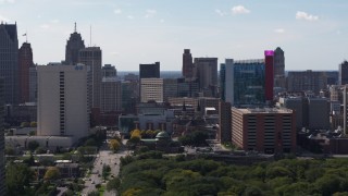 DX0002_194_041 - 5.7K aerial stock footage of churches between office building and the hotel and casino, Downtown Detroit, Michigan