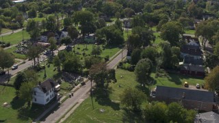 DX0002_195_006 - 5.7K aerial stock footage of flying by the Heidelberg Project art display and urban homes in Detroit, Michigan