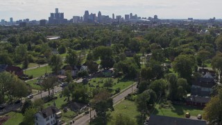 DX0002_195_007 - 5.7K aerial stock footage of the skyline seen from the Heidelberg Project art display and urban homes in Detroit, Michigan