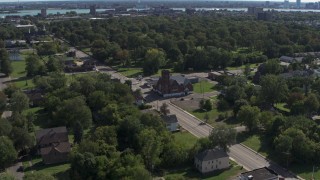 DX0002_195_013 - 5.7K aerial stock footage ascend over urban homes to orbit a church on Mt Elliott Street, Detroit, Michigan