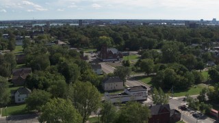DX0002_195_014 - 5.7K aerial stock footage of orbiting urban homes and a church on Mt Elliott Street, Detroit, Michigan