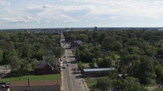 DX0002_195_015 - 5.7K aerial stock footage of circling urban homes and a church on Mt Elliott Street, Detroit, Michigan