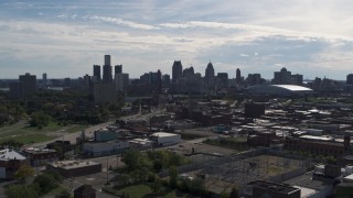 DX0002_195_019 - 5.7K aerial stock footage ascend toward the city's skyline from brick industrial buildings, Downtown Detroit, Michigan