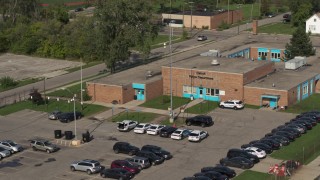 DX0002_195_032 - 5.7K aerial stock footage of the front entrance of a police station in Detroit, Michigan