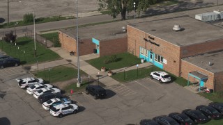 DX0002_195_033 - 5.7K aerial stock footage of the police station's front entrance in Detroit, Michigan