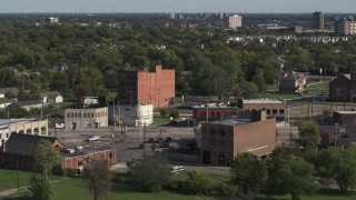 DX0002_195_038 - 5.7K aerial stock footage orbit a street intersection with two abandoned buildings in Detroit, Michigan