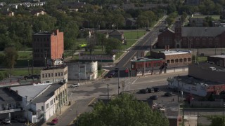 DX0002_195_039 - 5.7K aerial stock footage orbit a street intersection with abandoned buildings and shops in Detroit, Michigan