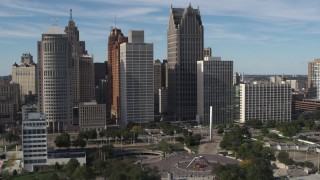 DX0002_196_001 - 5.7K aerial stock footage of orbiting towering skyscrapers across from Hart Plaza, Downtown Detroit, Michigan