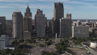 DX0002_196_003 - 5.7K aerial stock footage orbit towering skyscrapers across from Hart Plaza, Downtown Detroit, Michigan