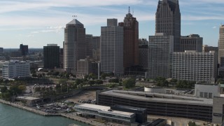 DX0002_196_009 - 5.7K aerial stock footage ascend away from tall skyscrapers and Hart Plaza, Downtown Detroit, Michigan