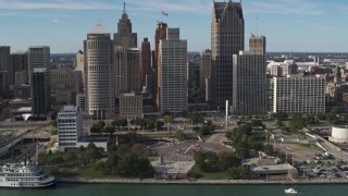 DX0002_196_011 - 5.7K aerial stock footage slowly orbit tall skyscrapers and Hart Plaza, Downtown Detroit, Michigan