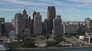 DX0002_196_015 - 5.7K aerial stock footage orbit of tall city skyscrapers behind Hart Plaza, Downtown Detroit, Michigan
