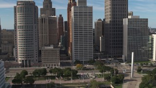 DX0002_196_019 - 5.7K aerial stock footage orbit and fly away from skyscrapers by Hart Plaza, Downtown Detroit, Michigan