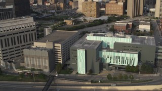 DX0002_196_044 - 5.7K aerial stock footage ascend while focused on the Detroit Public Safety Headquarters in Downtown Detroit, Michigan
