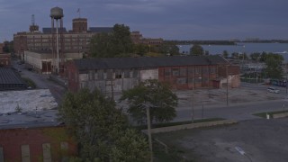DX0002_197_008 - 5.7K aerial stock footage of orbiting an abandoned factory building at sunset, Detroit, Michigan