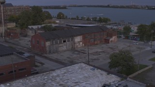 DX0002_197_009 - 5.7K aerial stock footage of an orbit of an abandoned factory building at sunset, Detroit, Michigan
