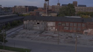 DX0002_197_010 - 5.7K aerial stock footage of an abandoned factory building at sunset, Detroit, Michigan