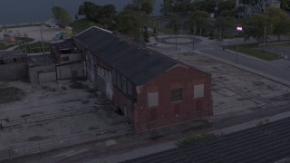 DX0002_197_012 - 5.7K aerial stock footage of orbiting an abandoned Northern Cranes factory building at sunset, Detroit, Michigan