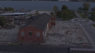 DX0002_197_013 - 5.7K aerial stock footage orbit an abandoned Northern Cranes factory building at sunset, Detroit, Michigan