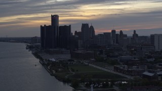 DX0002_197_034 - 5.7K aerial stock footage of GM Renaissance Center and the city's skyline seen from river at sunset, Downtown Detroit, Michigan