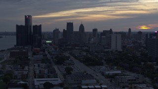 DX0002_197_040 - 5.7K aerial stock footage slowly flying past GM Renaissance Center and the skyline at sunset, Downtown Detroit, Michigan